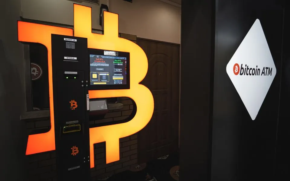Cryptocurrency ATM machine with person using it